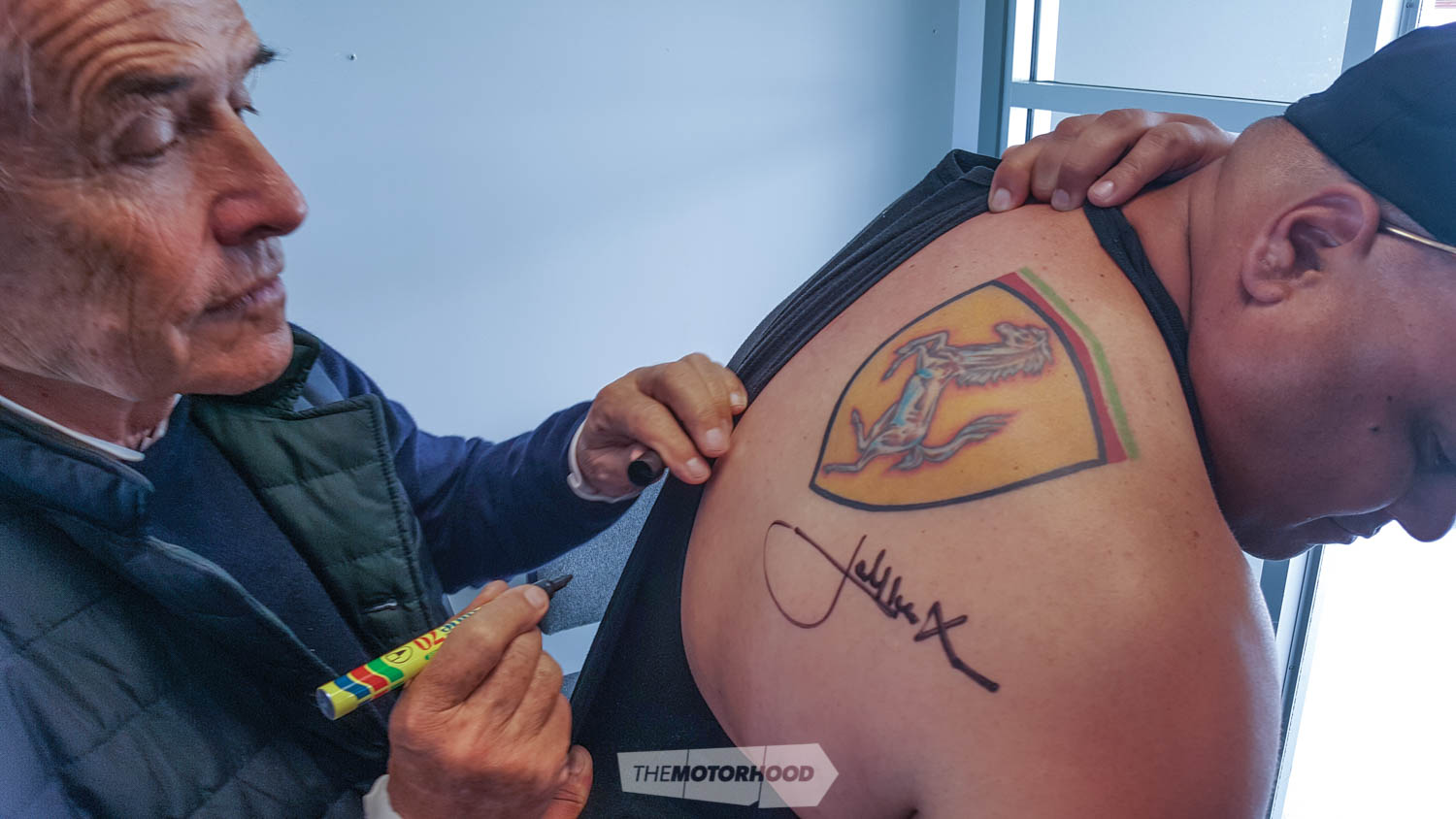 Jacky signs another autograph — this one to be tattooed