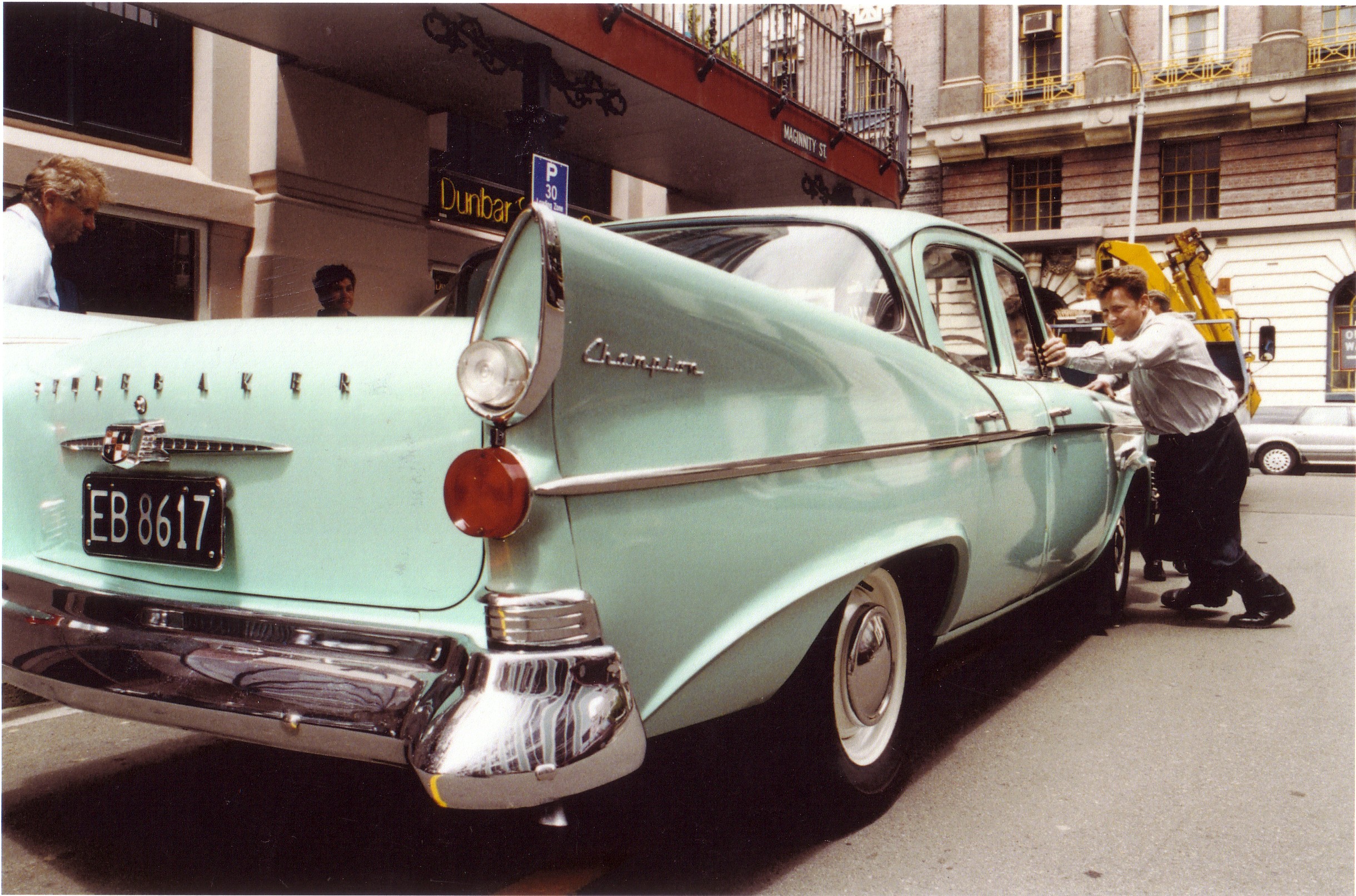 Andrew Grigg pushes the Studebaker into place for viewing prior to the January 1993 auction.