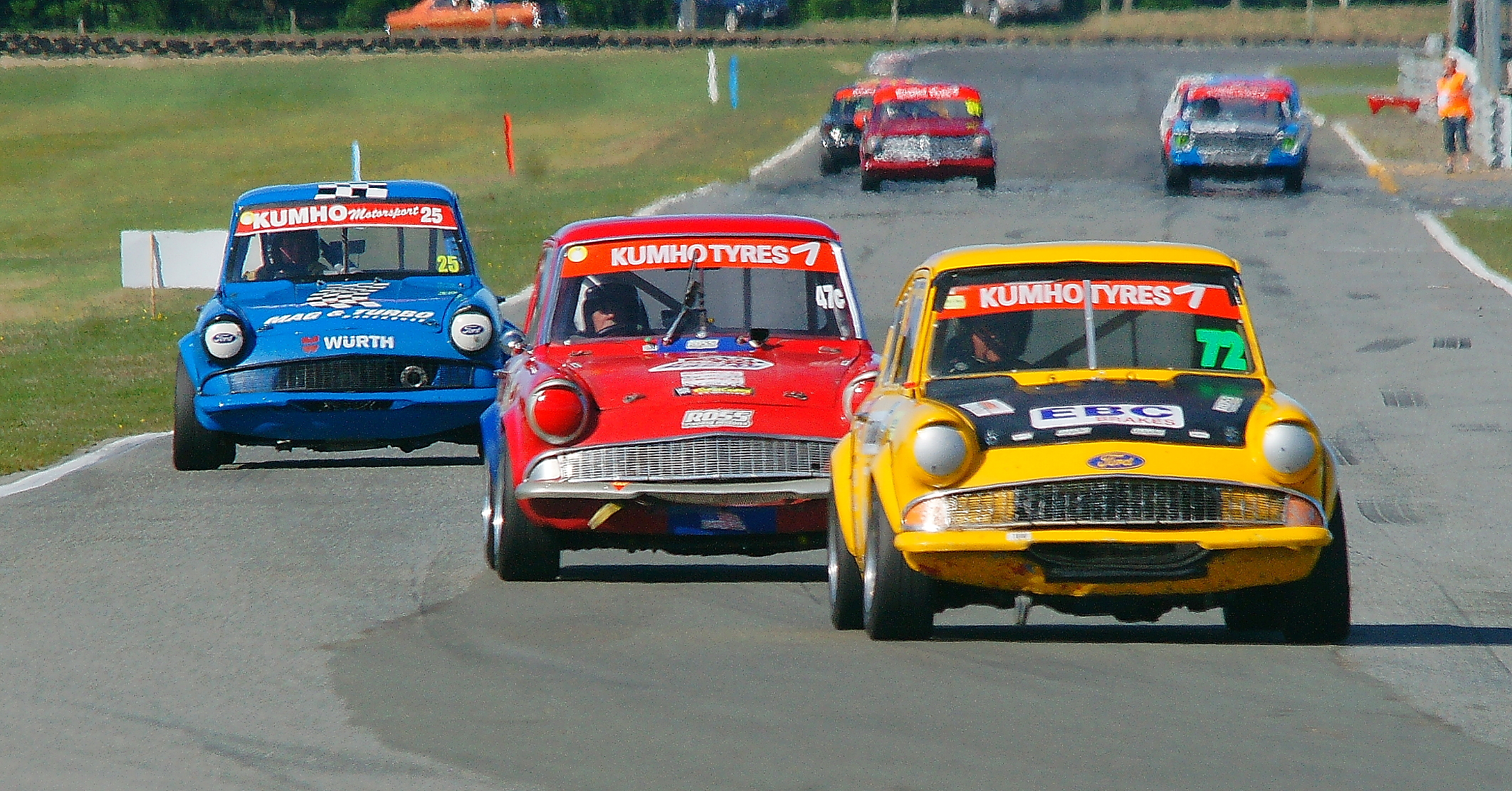  Russell Byfield (Christchurch) leads the Ford Anglias through the loop in the Pre-65 race 